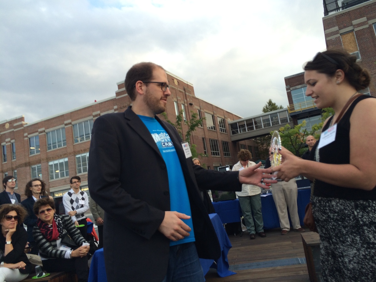 DHF Executive Director Andrew Coy picks up a Baltimore Innovation Award at the closing event of Baltimore Innovation Week 2014.