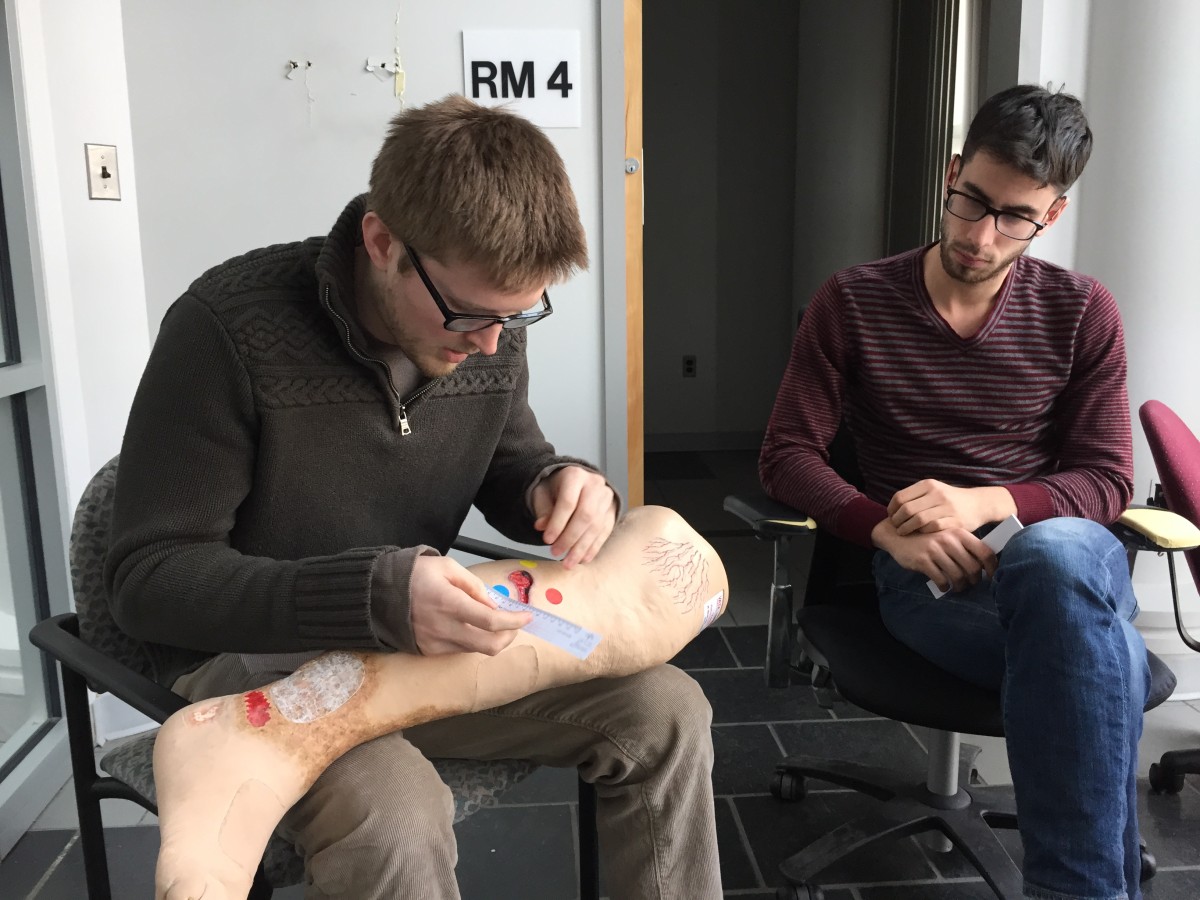 Tissue Analytics' Kevin Keenahan (left) and Josh Budman demonstrate old-school wound measurement techniques.