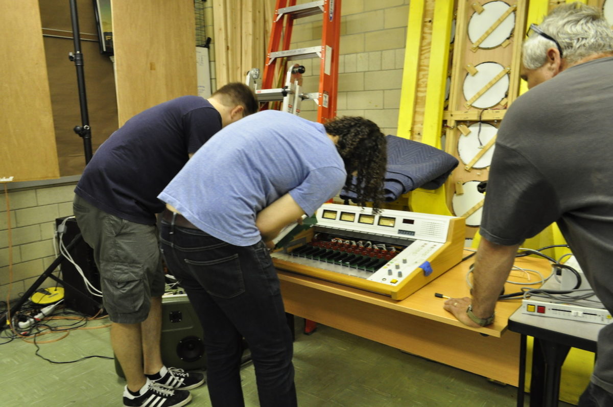 Hive76 open house attendees prepare a 12-channel soundboard for PhillyCAM's new community radio station.
