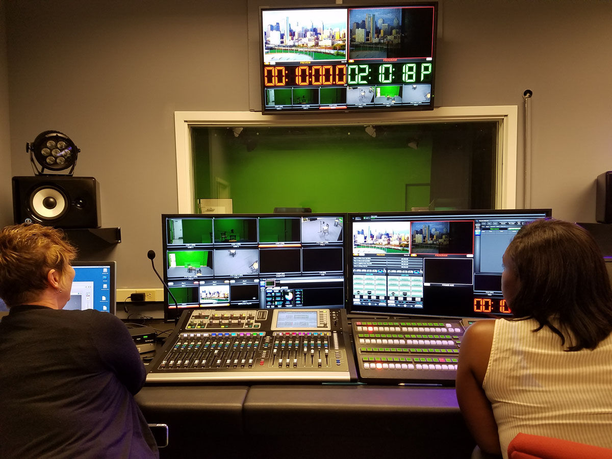 Shelly Wolfe (left) and Kyra Williams experiment with the new lights recently installed in the Philadelphia School District’s Public School TV Station.