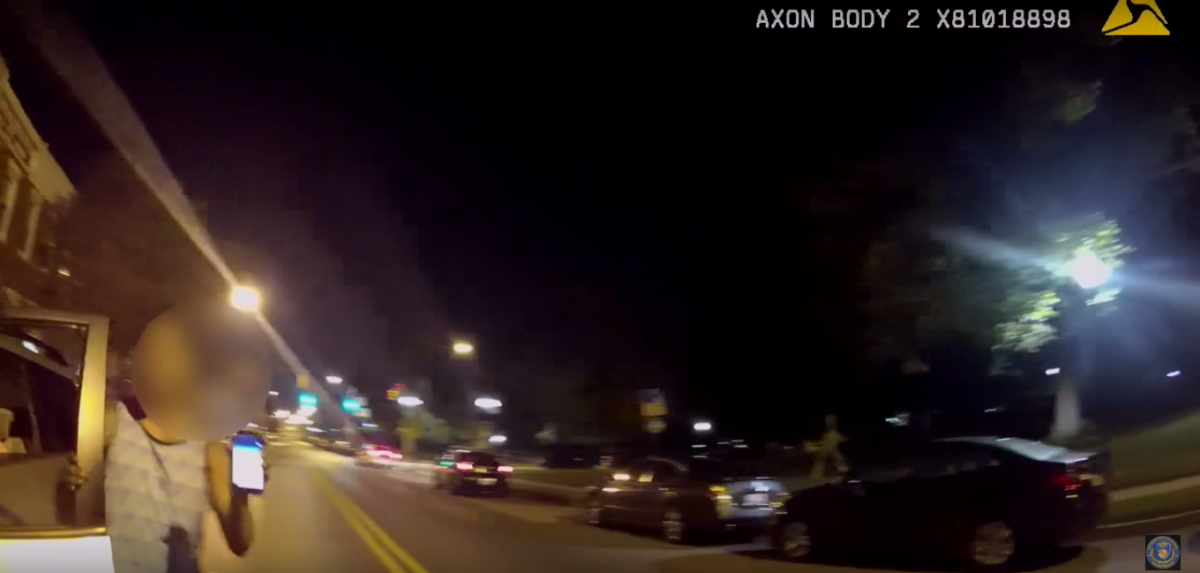 After crashing into a police car, a man holds up his phone to show that he was playing Pokémon Go.