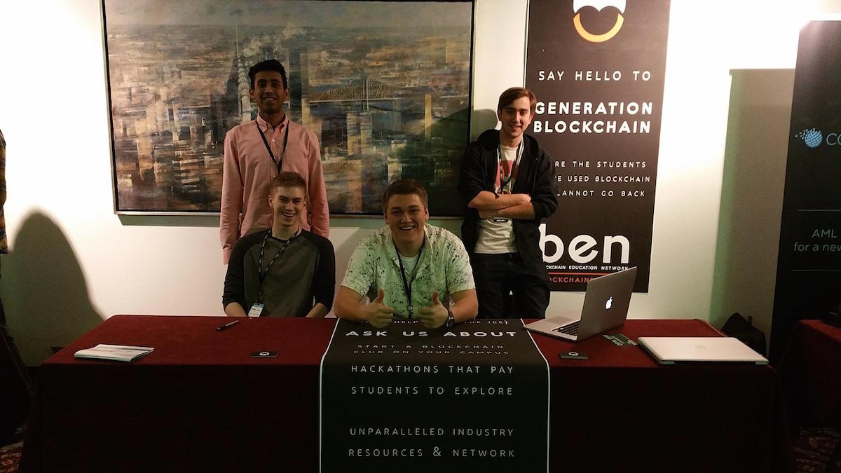 Dean Masley is sitting down to the left, with a few of his blockchain peers. Blockchain makes Dean happy.