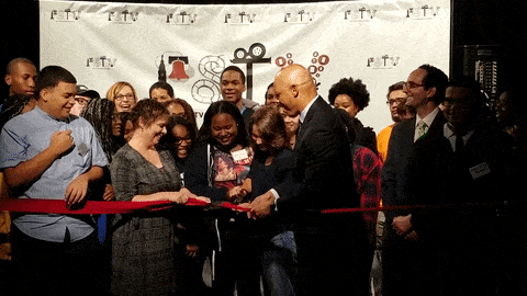 District officials and students celebrate the opening of the Public School TV.