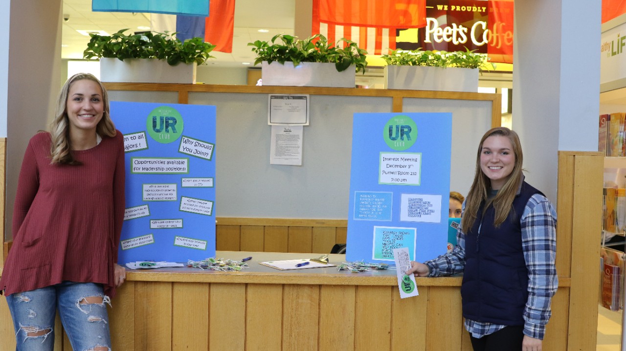 Members Morgan Popovich, left, and Casey Polasko represent the club in Trabant Student Center on campus.