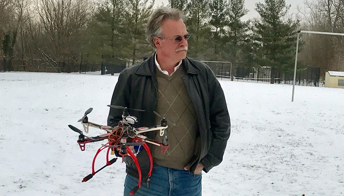 John Taylor and one of the drones he custom built. (Photo by Sukie Kim)