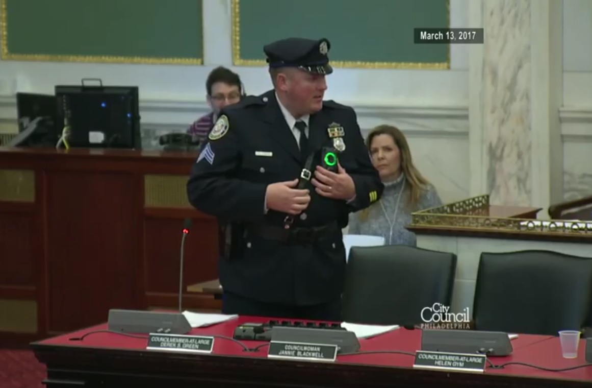 Capt. Mark Fisher giving City Council a demo of the body camera.