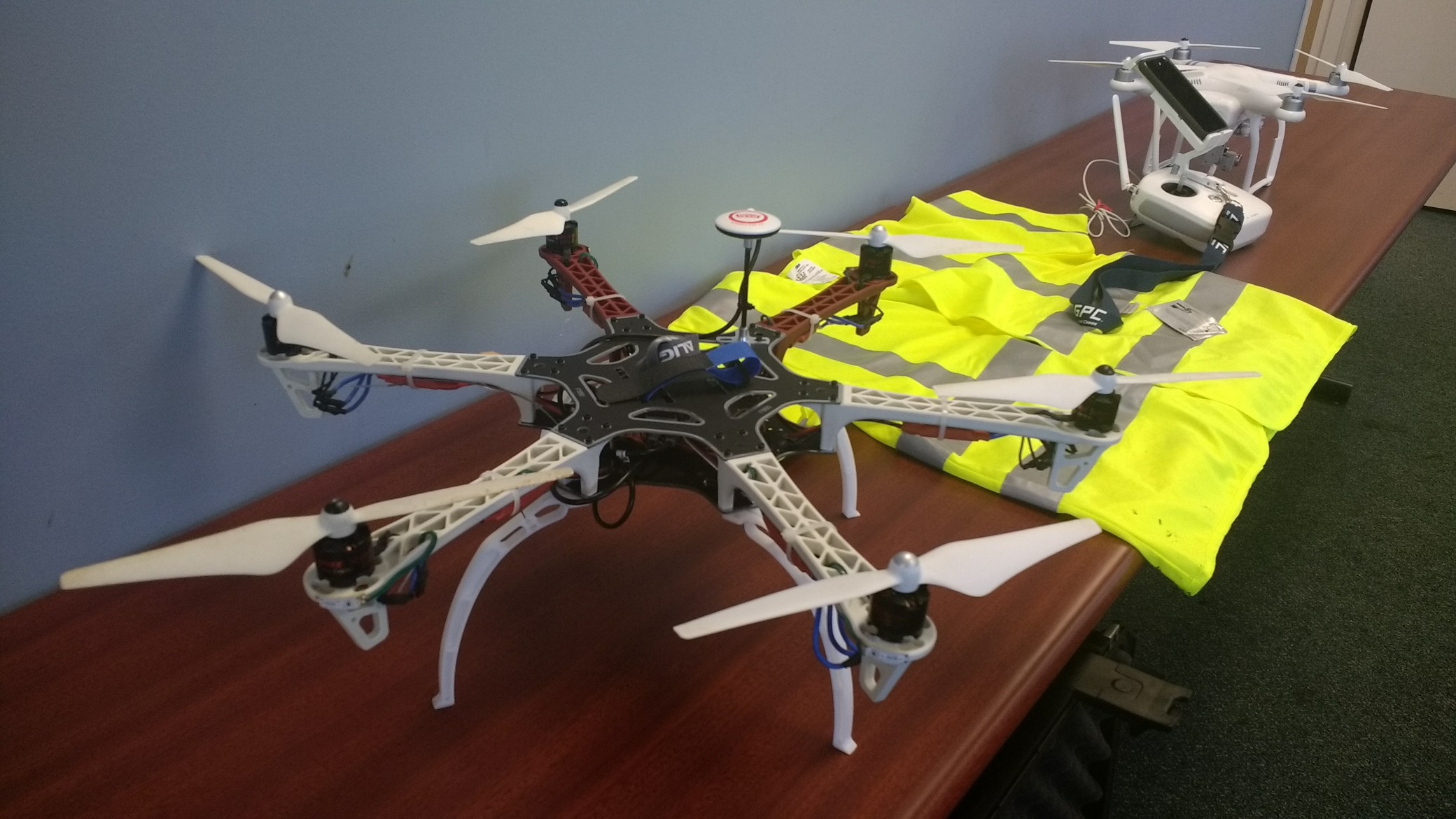 The drones students train with, including a $1,500 model (top) they own and can use for jobs in the future.