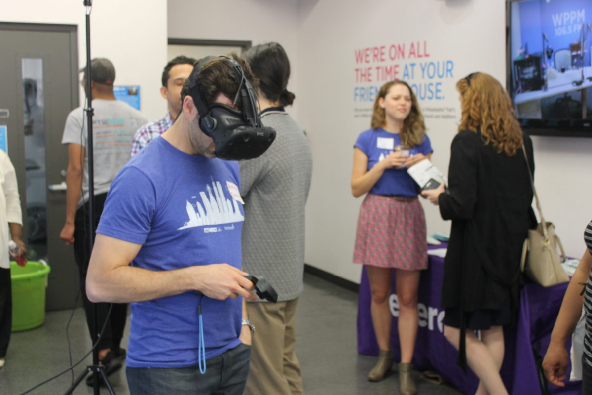 A man wearing a virtual reality headset at an event held at PhillyCAM, one of the grant-winning organizations.