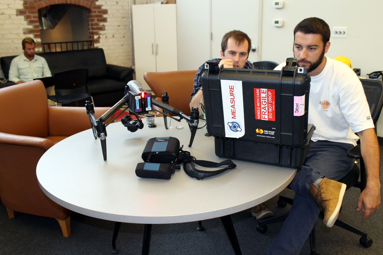 Two of Measure's employees working with a DJI Inspire 2 fitted with FLIR optics.