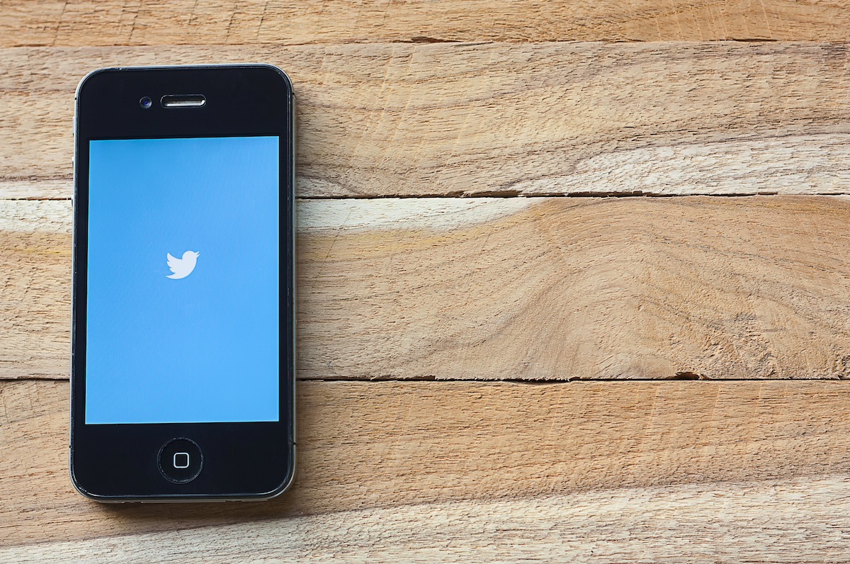The Twitter app opening on an iPhone, showing two big brands with DC offices.