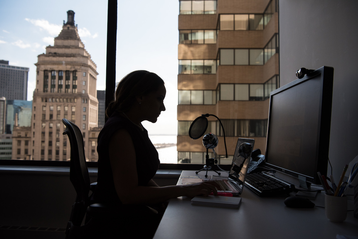A woman at a desk working at a computer