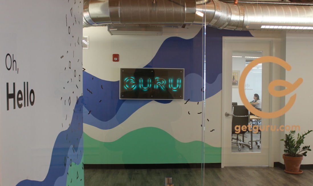 An entrance to an office with signage that reads Guru.