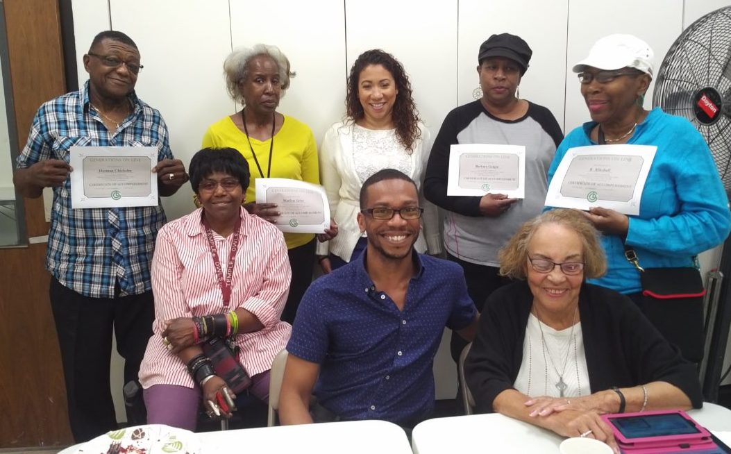 Senior citizens of color holding up certificates of training.
