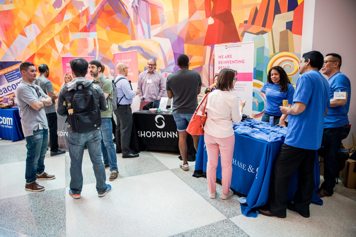 Companies mingle with attendees at the #PTW18 Dev Conference.