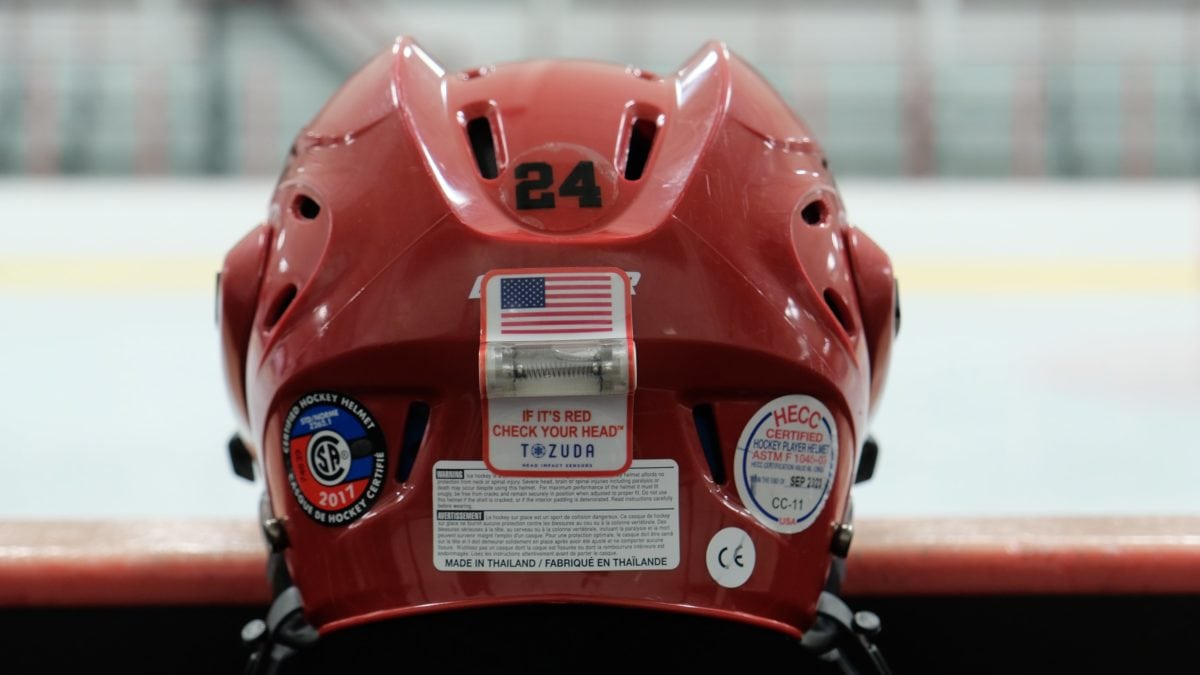 A red helmet with a small capsule attached to the back