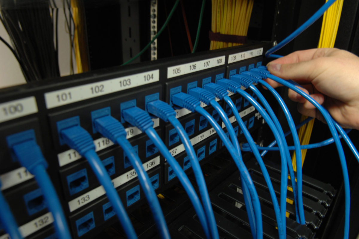 A server rack with blue cables going into them