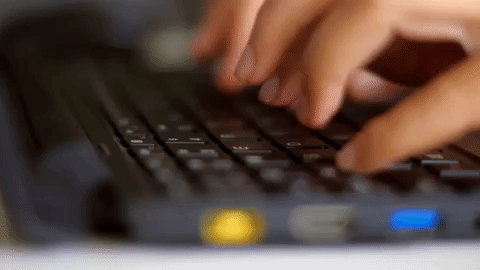 Hands typing on a keyboard.