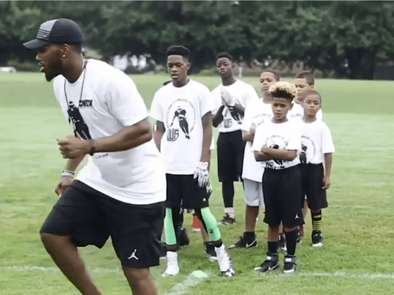 Instructors lead football drills for Delaware kids