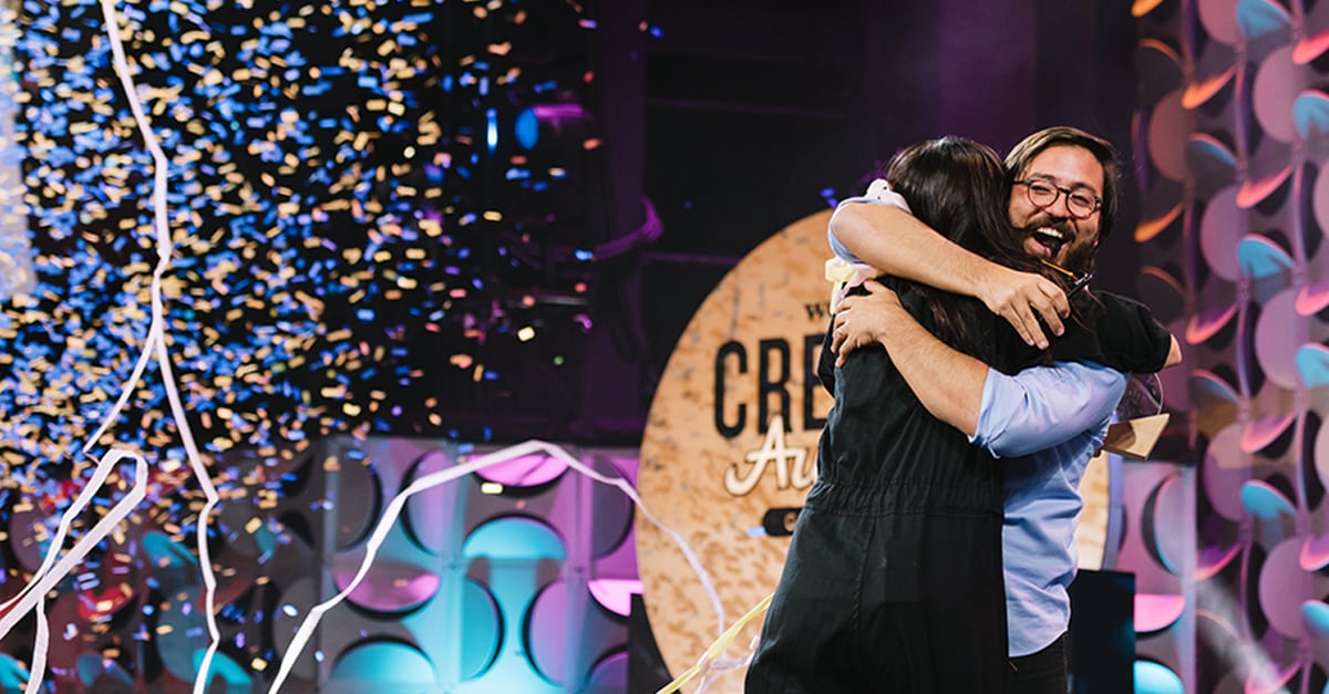 Creator Awards participants embrace on stage