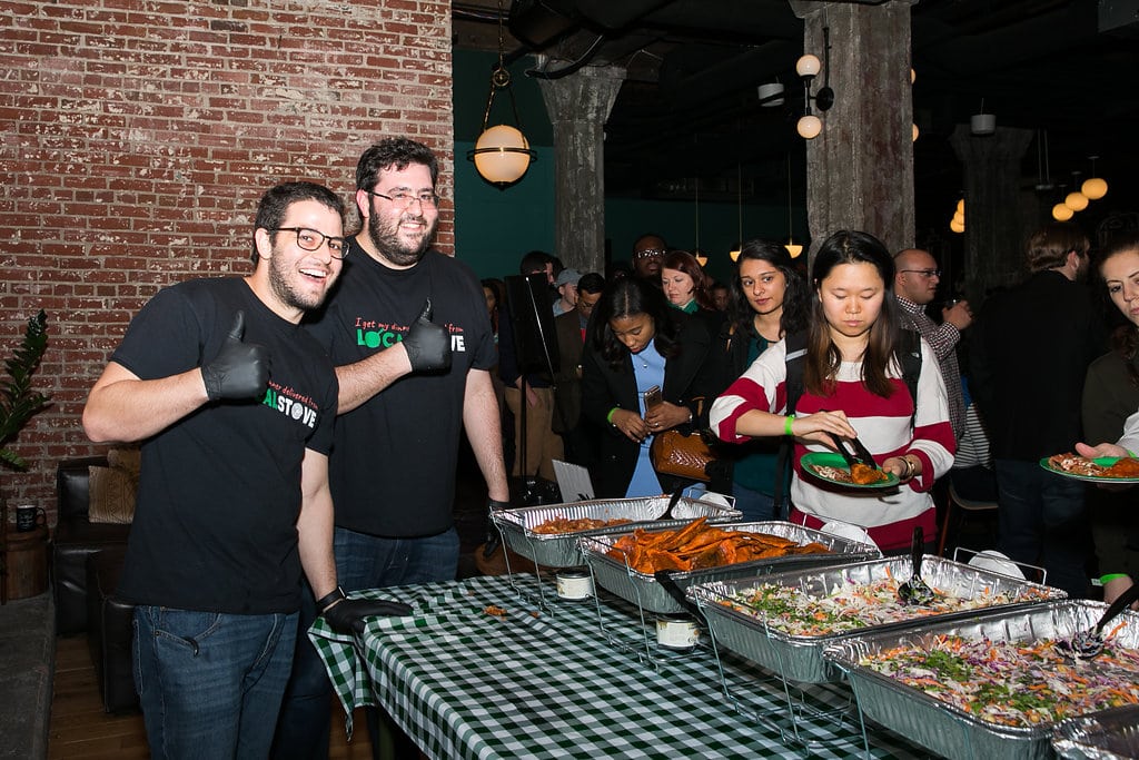 Two founders in front of catering trays