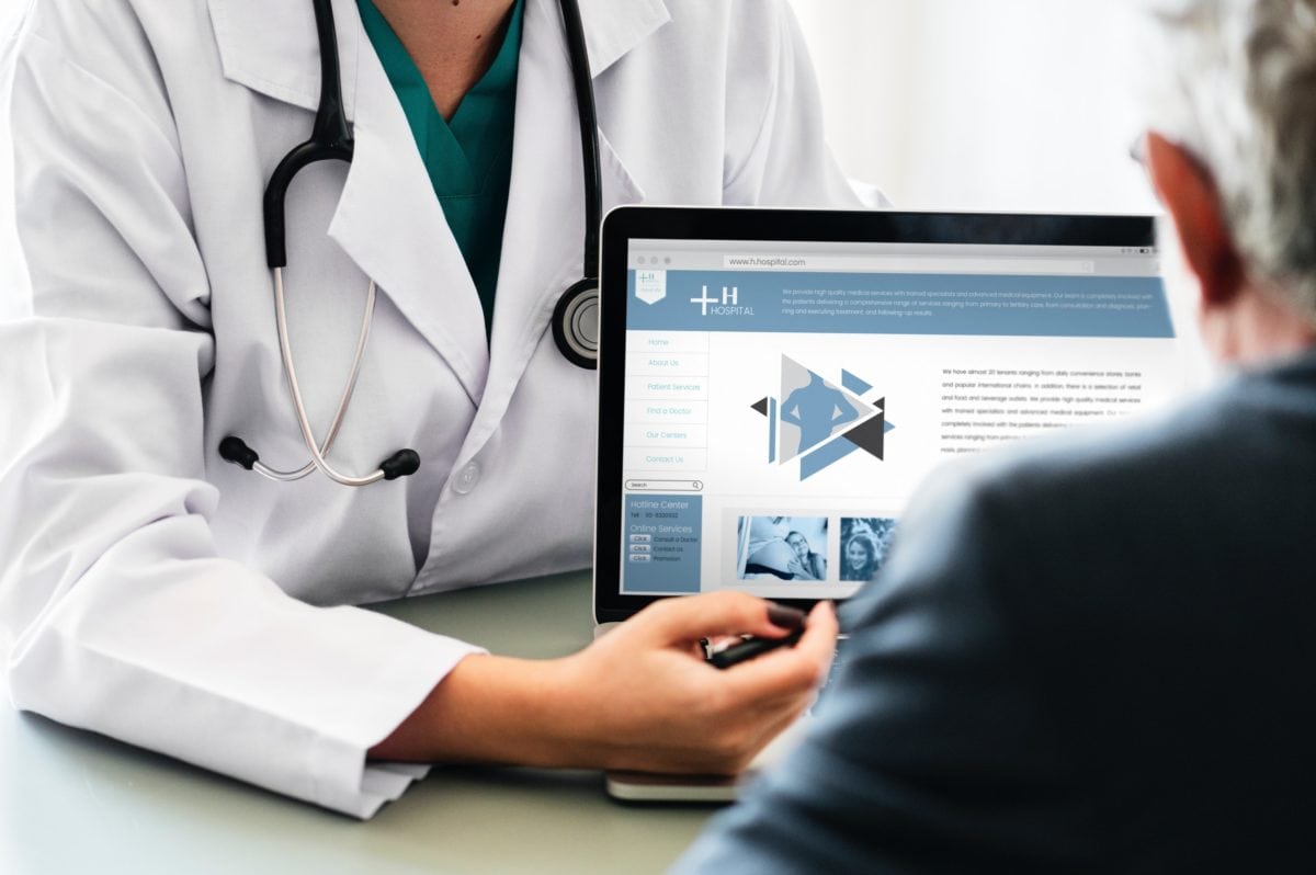 Doctor showing a patient a computer screen