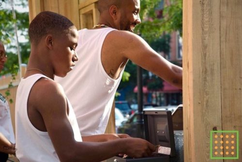 Jason Aviles (right) serving healthy goods from the Wilmington Green Box kiosk on Market Street.