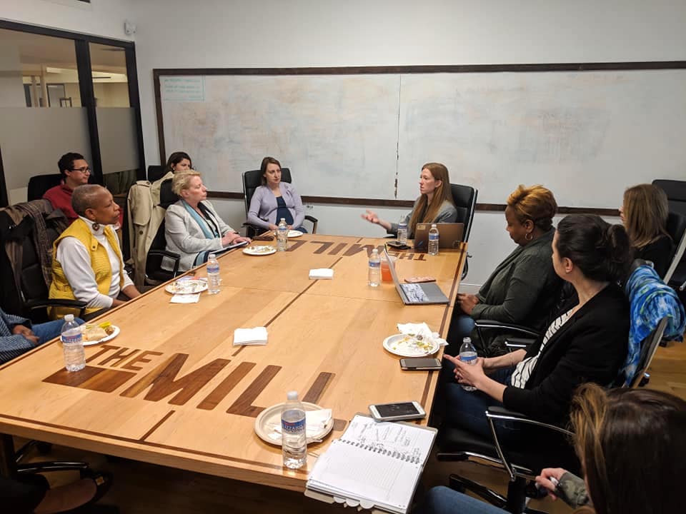 Women sitting at a table, talking