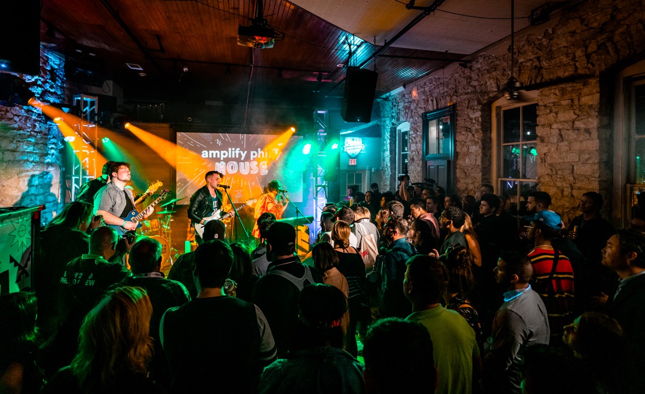 A crowd of people watching musicians play