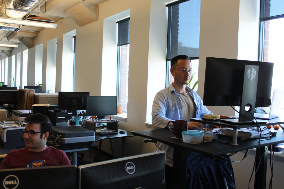 A man works at a desktop computer