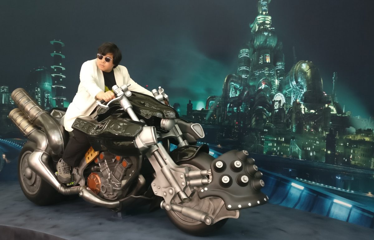 A man poses on a futuristic motorcycle