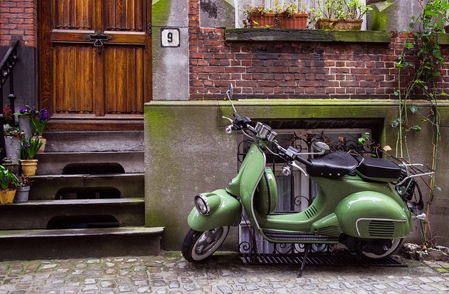 A green moped parked in front of a house