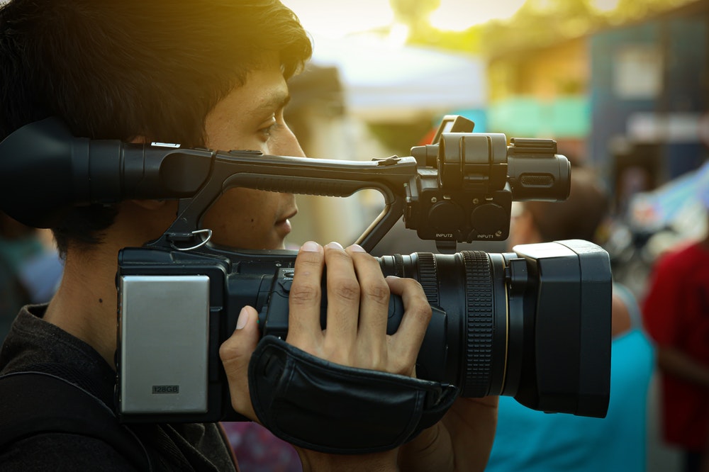 man with a film camera
