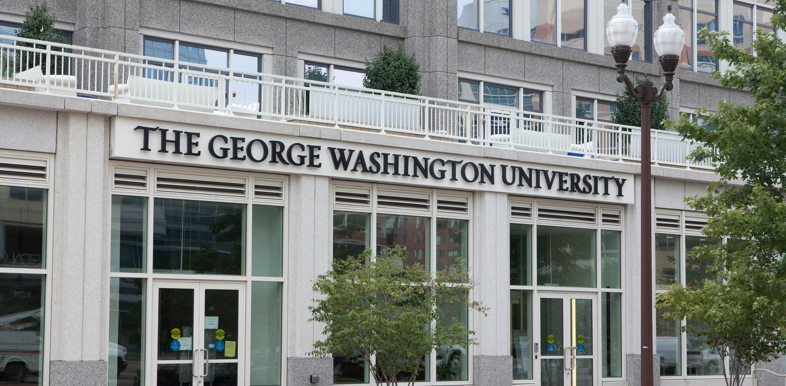 A building on the George Washington University campus, featuring large windows and the school's name on the building façade.