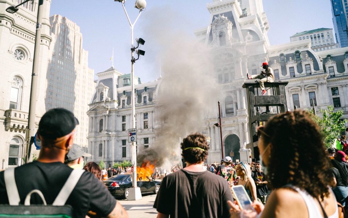 photo of a car on fire outside of philadelphia city hall