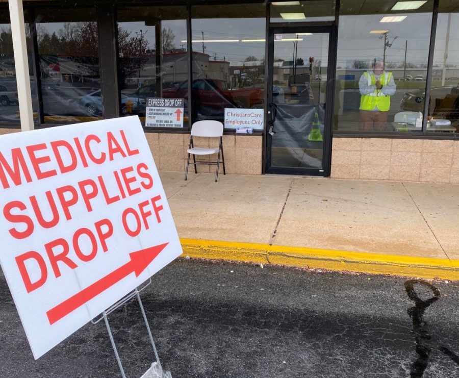 A sign points to a medical supply drop off