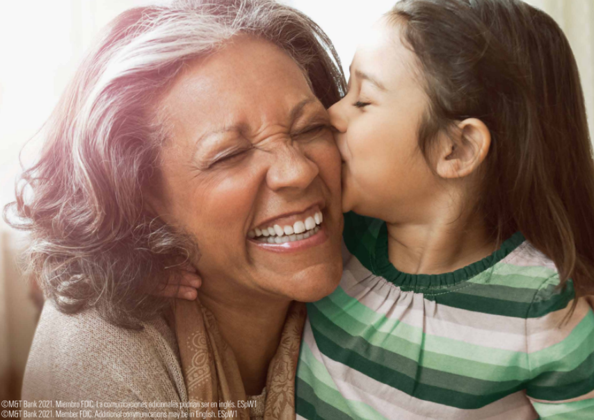Girl kissing her grandmother on the cheek