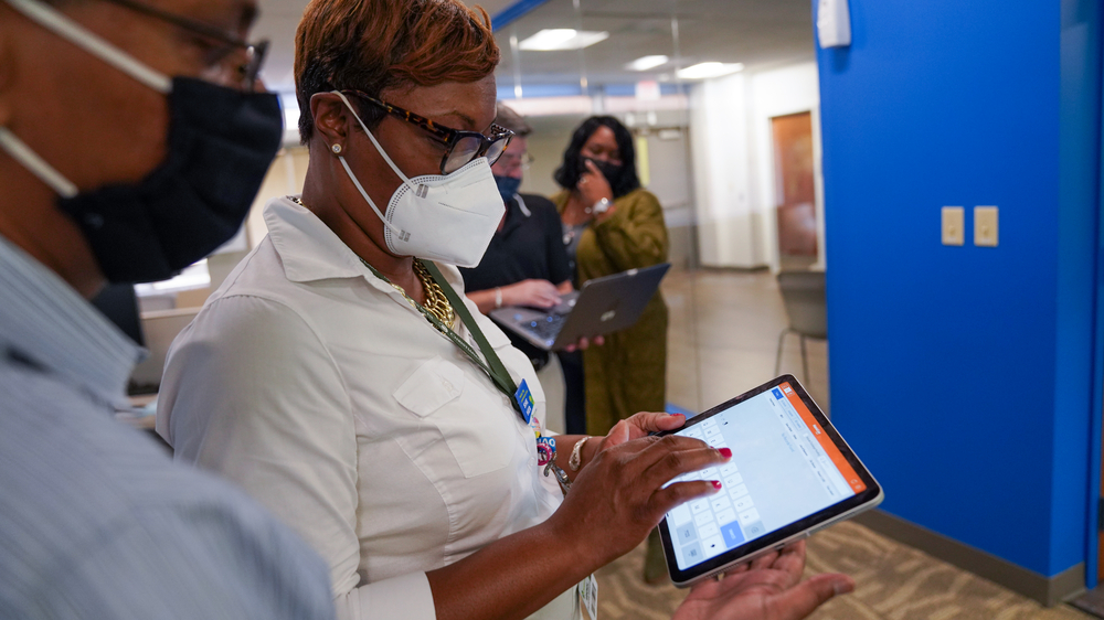HomeHealth Nurse Manager Arhonda Osborne R.N. discusses software solutions with Senior IT Application Analyst Saqueb Ali.