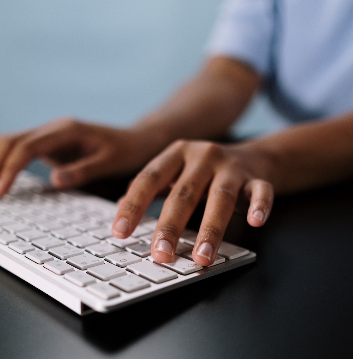 person typing on laptop