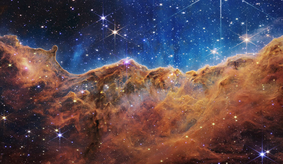 The image is divided horizontally by an undulating line between a cloudscape forming a nebula along the bottom and a clearer upper portion.