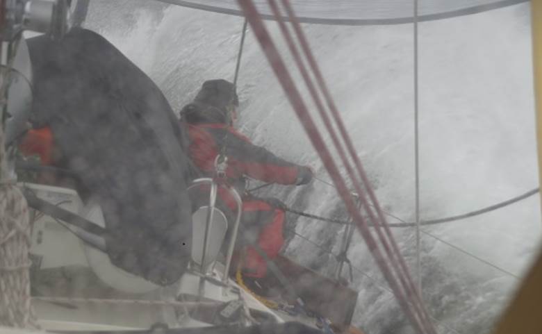 Charles Simon bundled up, securing some equipment in the artic