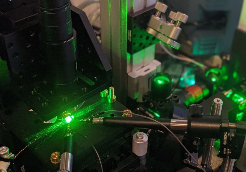 Lab technology at Quantum Catalyzer emits a bright green light.