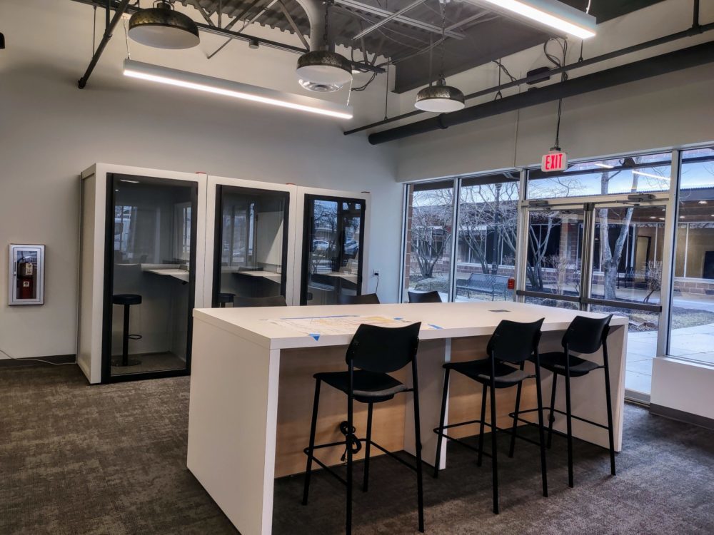Carvertise collaborative area with phone booths.