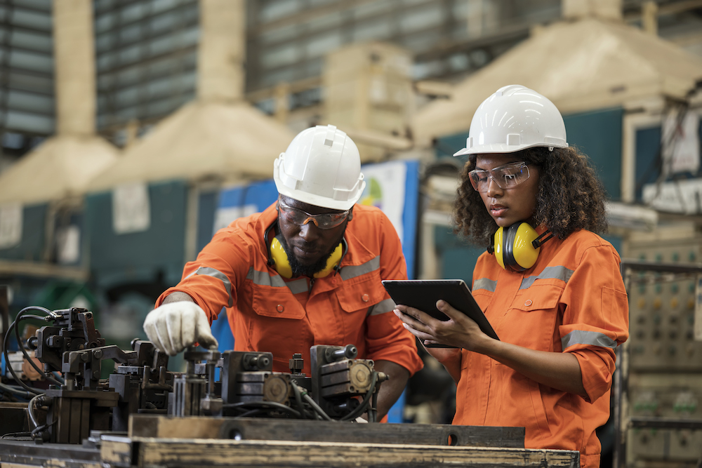 Black mechanical engineers are working together to inspect of welding jig assembly based on the process control plan in a production line.