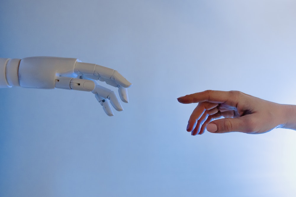 A human hand reaching out to a robot hand.