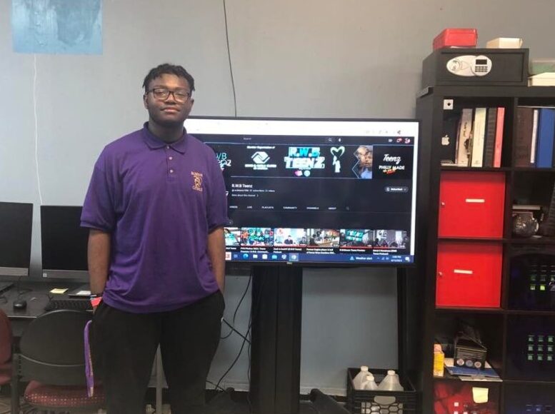 Kamerin Isley standing in front of a big TV