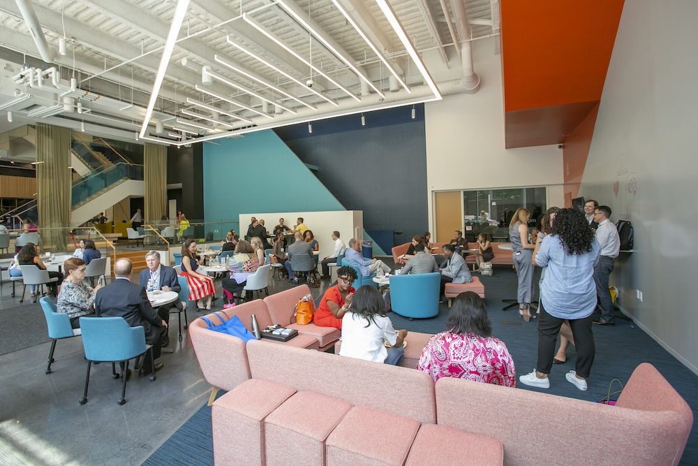 A crowd of people gathering in the Quorum Lounge at the University City Science Center.