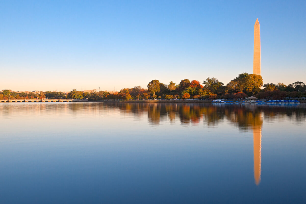 Autumnal view of the washington monument reflected in the tidal basin at twilight.