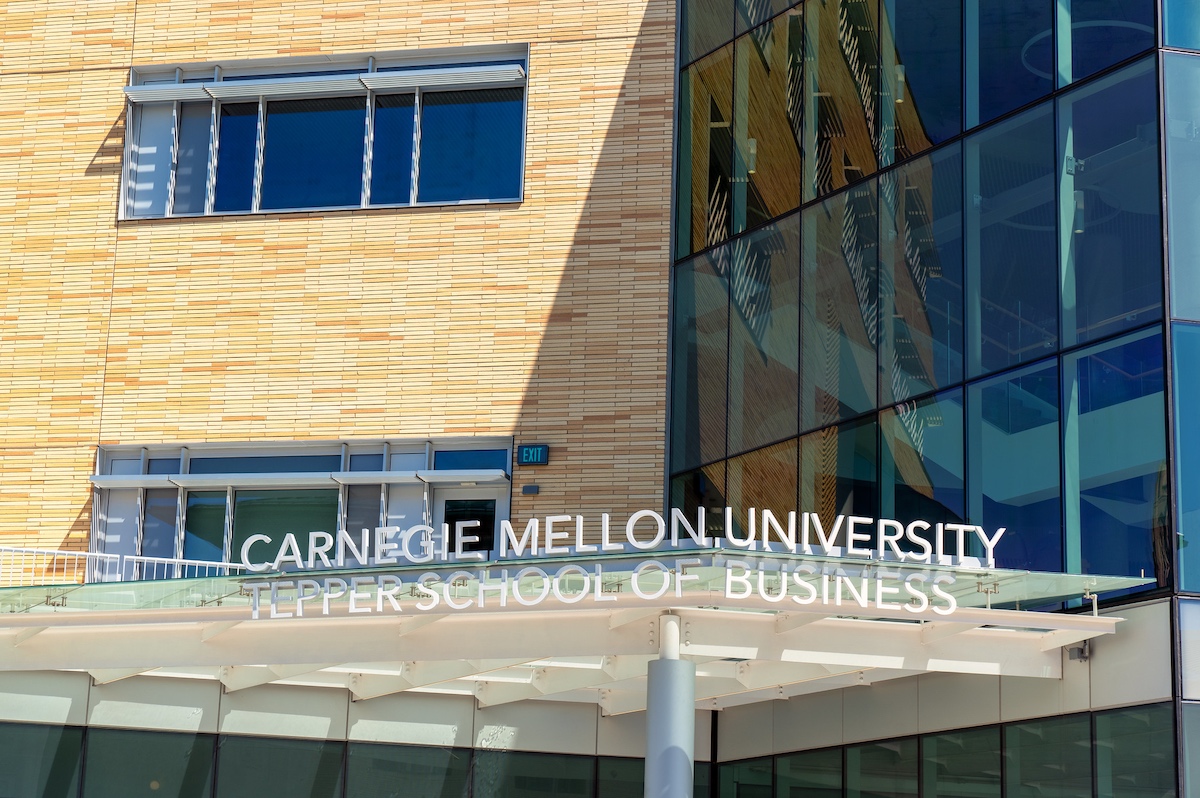 A glass building with a sign that says carlisle melbourne university.