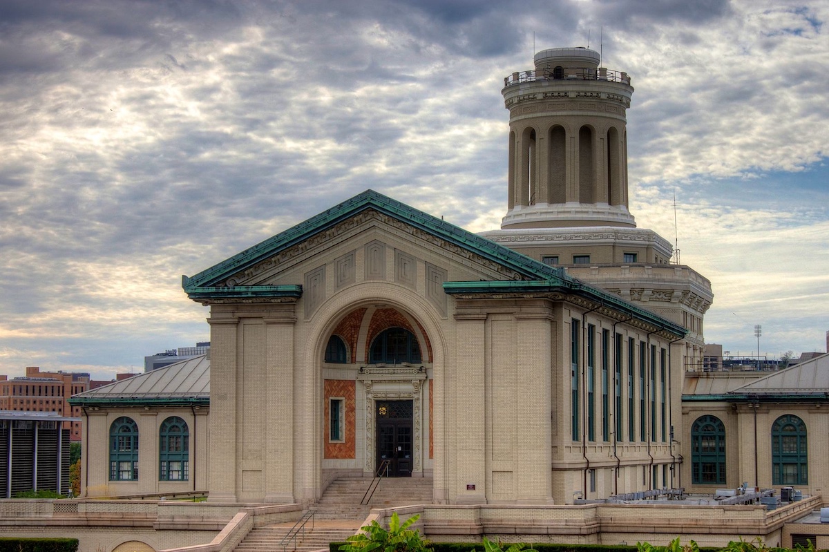 A large building with a clock tower in the background.