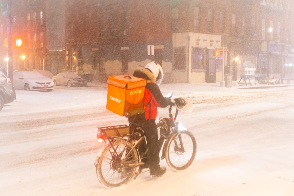 A person riding a bicycle on a snowy street.